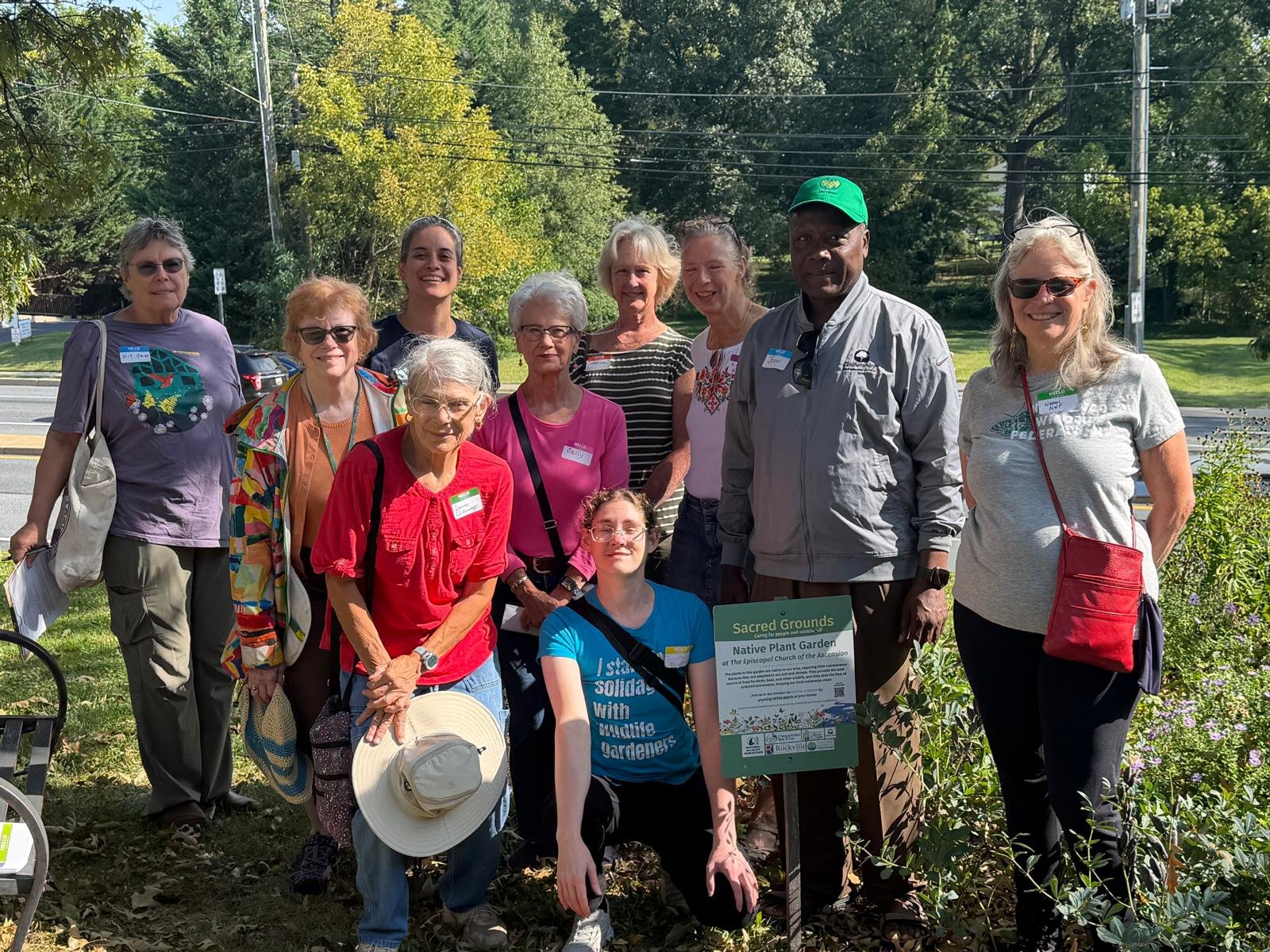 Participants gathered beside the Sacred Grounds native plant garden sign at The Episcopal Church of the Ascension.
